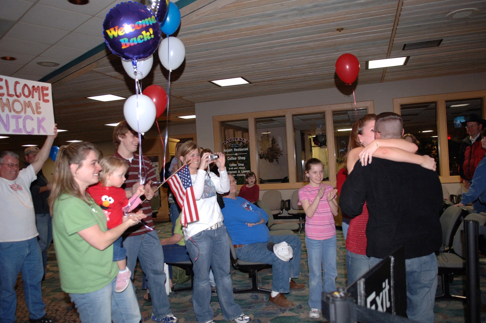 Staff Sgt. Nick Shatek is greeted home by Alyssa Laures and family at Rapid City Regional Airport March 21. Sergeant Shatek, assigned to the 28th Security Forces Squadron, returned from a deployment to Southwest Asia in support of operations Iraqi Freedom and Enduring Freedom. (U.S. Air Force photo/Airman 1st Class Angela Ruiz) 