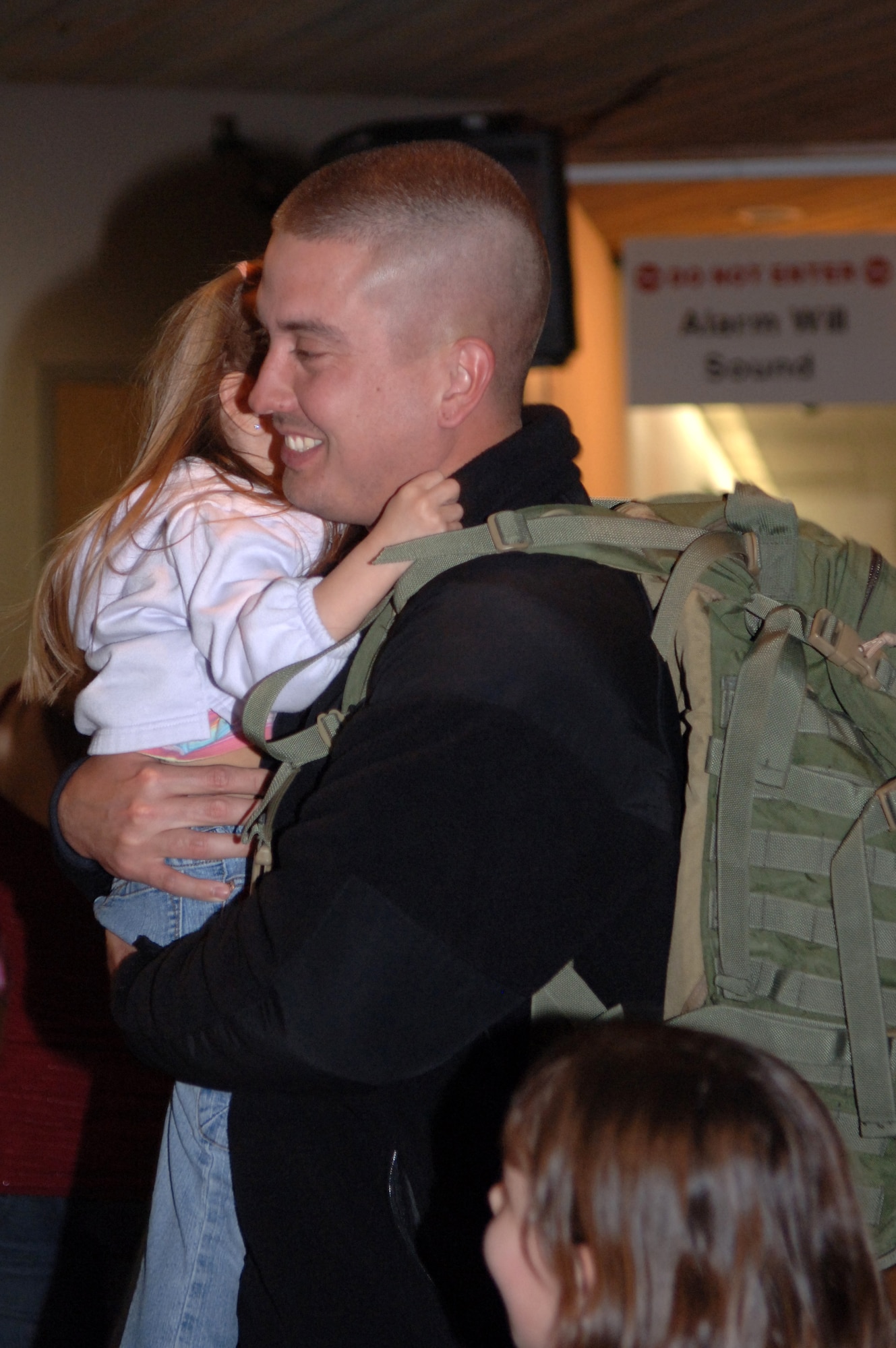 Staff Sgt. Paul Flanagan hugs his daughter, Maghan, upon arriving at Rapid City Regional Airport March 21. Sergeant Flanagan, assigned to the 28th Security Forces Squadron, returned from a deployment to Southwest Asia in support of operations Iraqi Freedom and Enduring Freedom. (U.S. Air Force photo/Airman 1st Class Angela Ruiz)