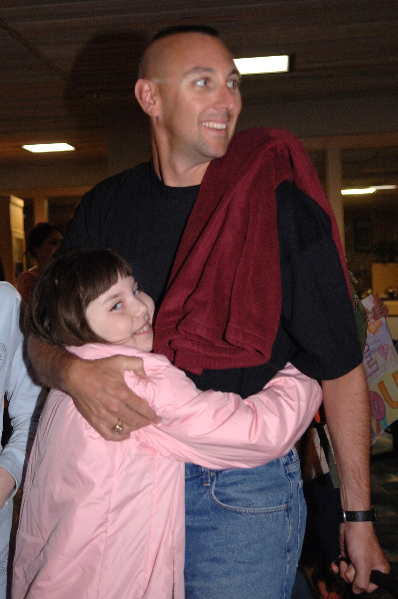 Tech. Sgt. Dwan Allen is greeted home by his daughter, Jennifer, at Rapid City Regional Airport March 21. Sergeant Shatek, assigned to the 28th Security Forces Squadron at Ellsworth Air Force Base, S.D., returned from a deployment to Southwest Asia in support of operations Iraqi Freedom and Enduring Freedom. (U.S. Air Force photo/Airman 1st Class Angela Ruiz)