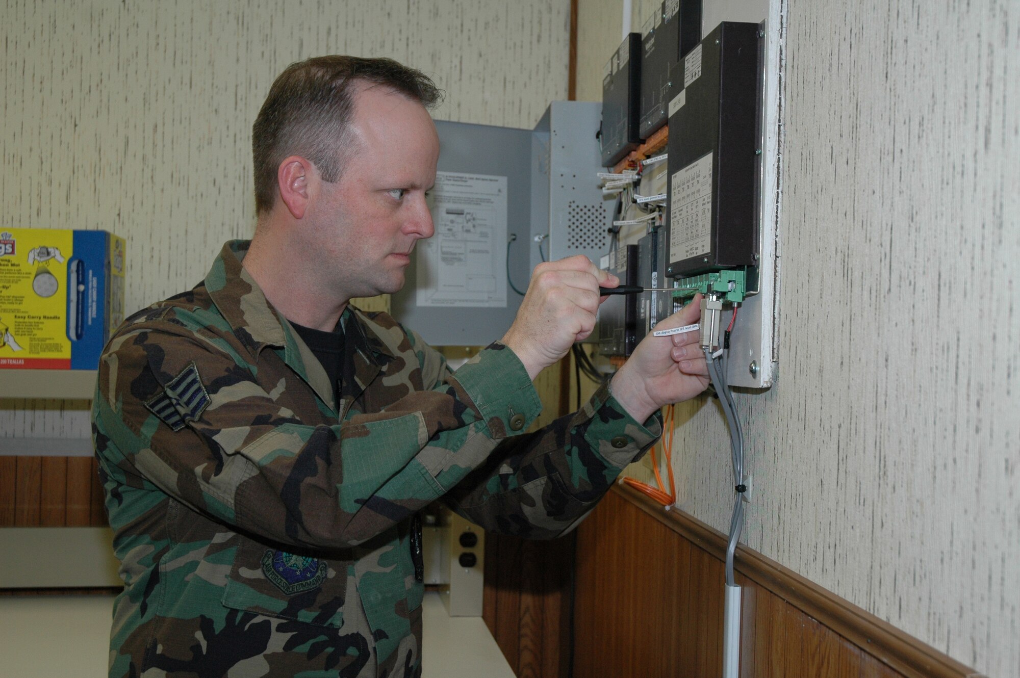 Staff Sgt. Gregory Chapman,  the NCOIC of the 341st Maintenance Operations Squadron’s Visual Imagery and Intrusion Detection Systems section, works on the wiring for the Weapons Storage Area.