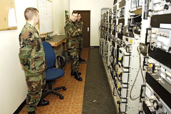 FAIRCHILD AIR FORCE BASE, Wash. -- Senior Airman Matthew Swift and Staff Sgt. Thomas Hersman, 92nd Communications Squadron airfield systems technicians, describe the air traffic control radio system to Col. Gregory Touhill (center), Air Mobility Command director of communications. Colonel Touhill visited with the 92nd CS on Monday and Tuesday to discuss upcoming changes to the communications career field. (U.S. Air Force photo/Senior Airman Anthony Ennamorato)
