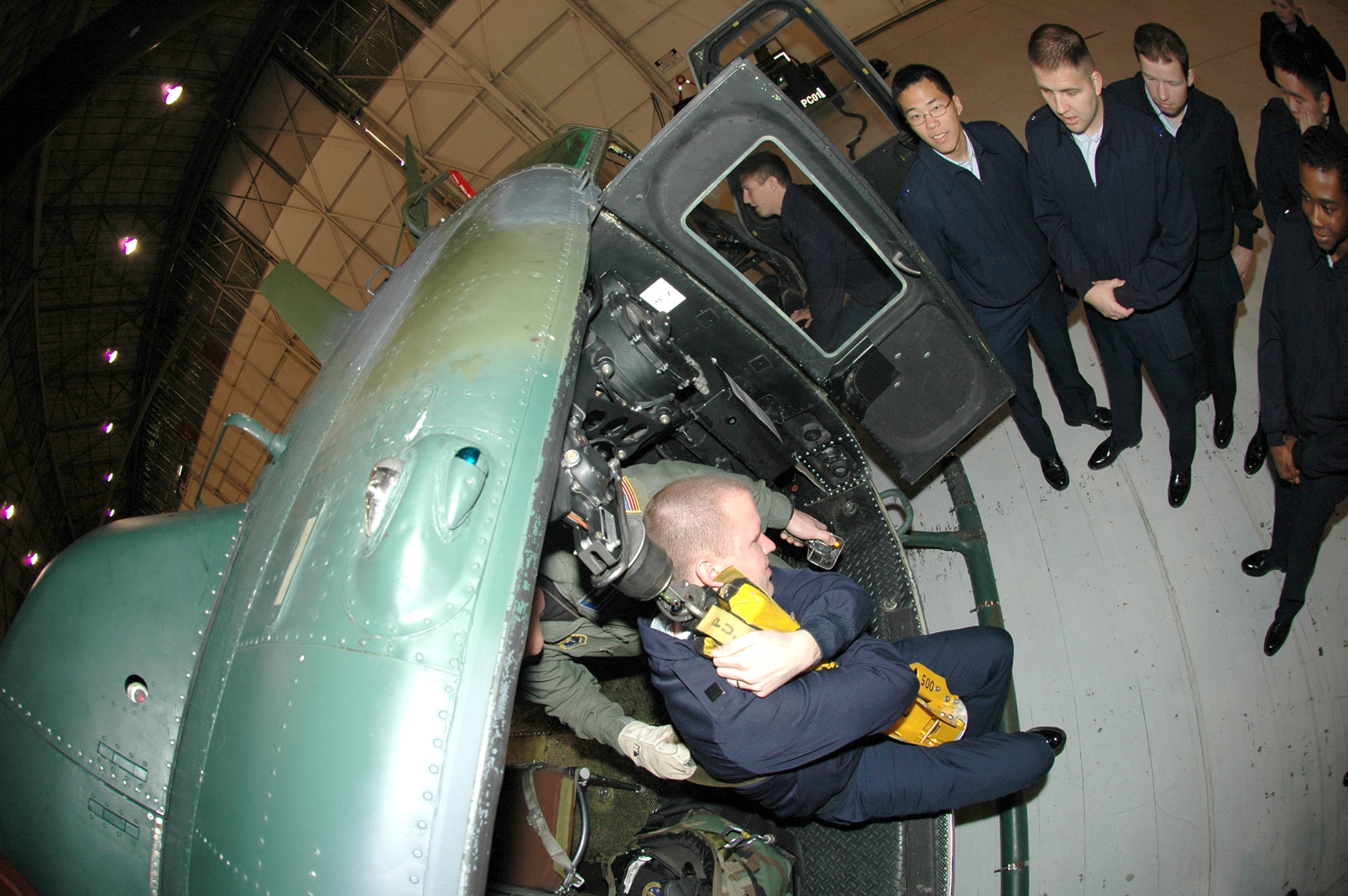 FAIRCHILD AIR FORCE BASE, Wash. -- Tech. Sgt. Keith Piccioni, 36th Rescue Flight evaluator flight engineer, demonstrates how the UH-1N Huey’s hoist is used for rescue operations. Sergeant Piccioni is using the hoist to pull Cadet Benjamin Quigley, University of Utah ROTC Detachment 850 special activities squadron commander, into the helicopter. The cadets toured many facilities on base Tuesday and Wednesday. (U.S. Air Force photo/Staff Sgt. Kristian Carter)
