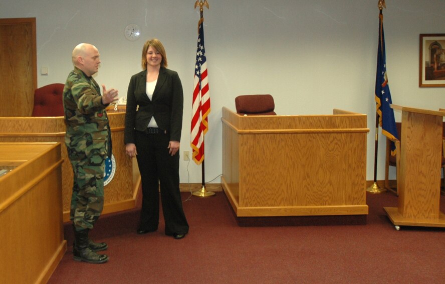 MINOT AIR FORCE BASE, N.D. -- Capt. Jacob Simpson, assistant base staff judge advocate, explains military justice to Lisa Martwick, a Drake Public School junior, here March 22. Ms. Martuck and several other high-school students shadowed legal, security forces and public affairs to familiarize themselves with these specialties and the Air Force. (U.S. Air Force photo by Senior Airman Danny Monahan)