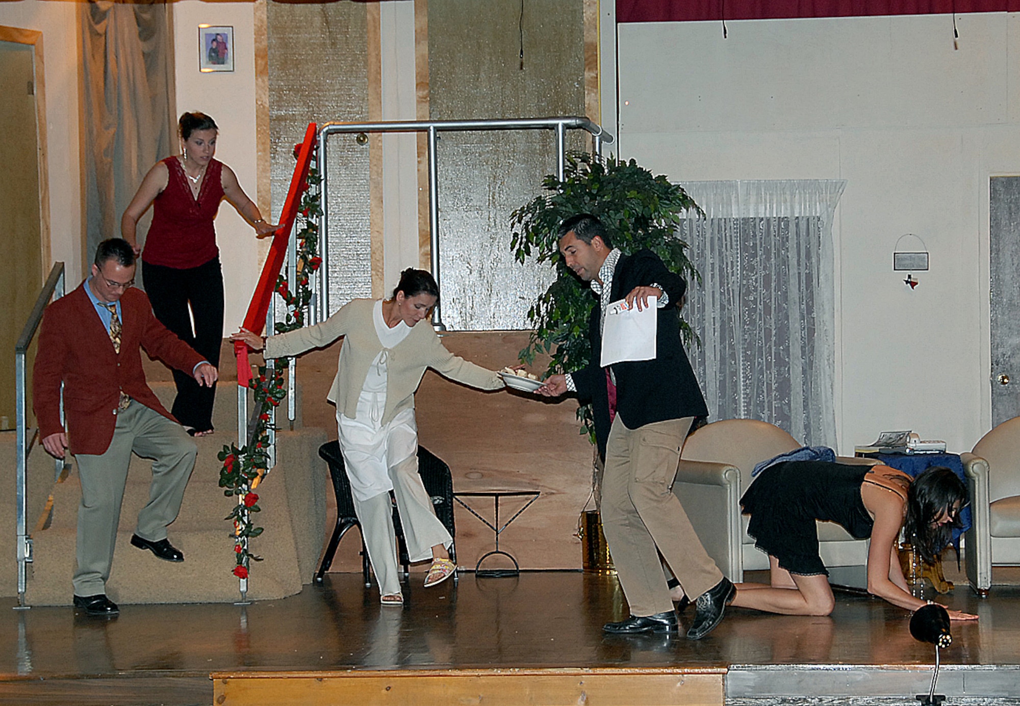 ENJJPT Players cast members in "Noises Off" look for a contact lense during the opening night of the play at the Sheppard Community Center March 21. (U.S. Air Force photo/Mike Litteken)