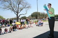 Jason Baca lets one of his birds show off for the audience while the SeaWorld and Busch Gardens Animal Adventures Tour Vehicle was on base March 15. The 38-foot tour vehicle, with its various reptiles and birds, was on Lackland Air Force Base, Texas, to give the community a chance to meet and interact with the animals. The Animal Adventures Tour Vehicle will visit more than 20 of the nation's largest cities during the tour year. (USAF photo by Robbin Cresswell)