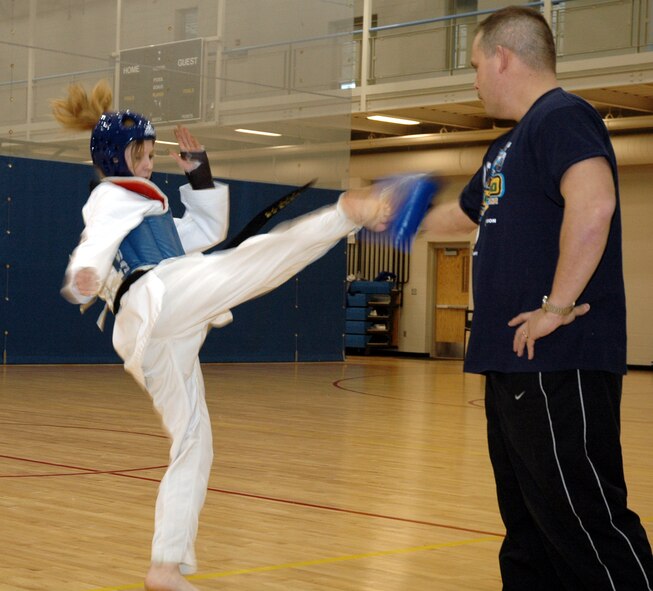 MINOT AIR FORCE BASE, N.D. -- Chelsi Davis, 14, practices her Tae Kwon Do skills with her father Lt. Col. Jed Davis, 741st Missile Squadron commander, at the McAdoo Sports and Fitness Center. Chelsi recently earned the bronze medal at the U.S. Open Tae Kwon Do championship in Orlando, Fla. (U.S. Air Force photo by Capt. James Bressendorff)