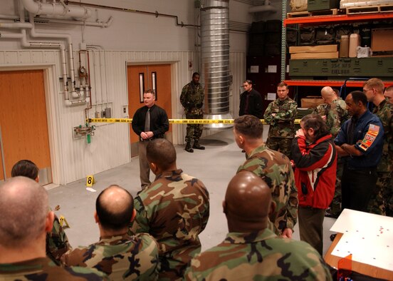 EIELSON AIR FORCE BASE, Alaska -- Tech. Sgt. Christopher Stone, 354th Security Forces Squadron, talks to Senior Leadership and Commanders for Mission Support Group Standup about crime scene investigation on March 21. Following the business-as-usual staff meetings, the attendees are given tours and briefed by Airmen and Non-Commissioned Officers on specific operations.  (U.S. Air Force Photo by Airman 1st Class Jonathan Snyder)