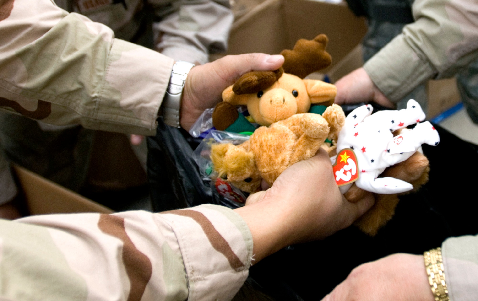 Department of Defense civilians and coalition servicemembers banded together March 16 to sort bags of clothes, toys, and shoes to donate to approximately 1,000 local Afghans at a refugee camp in Dar Ul Aman in support of the volunteer community reach program.  The program volunteers provide this service every month thanks to donated items from U.S. citizens.  (U.S. Air Force photo/Tech. Sgt. Cecilio M. Ricardo Jr.) 