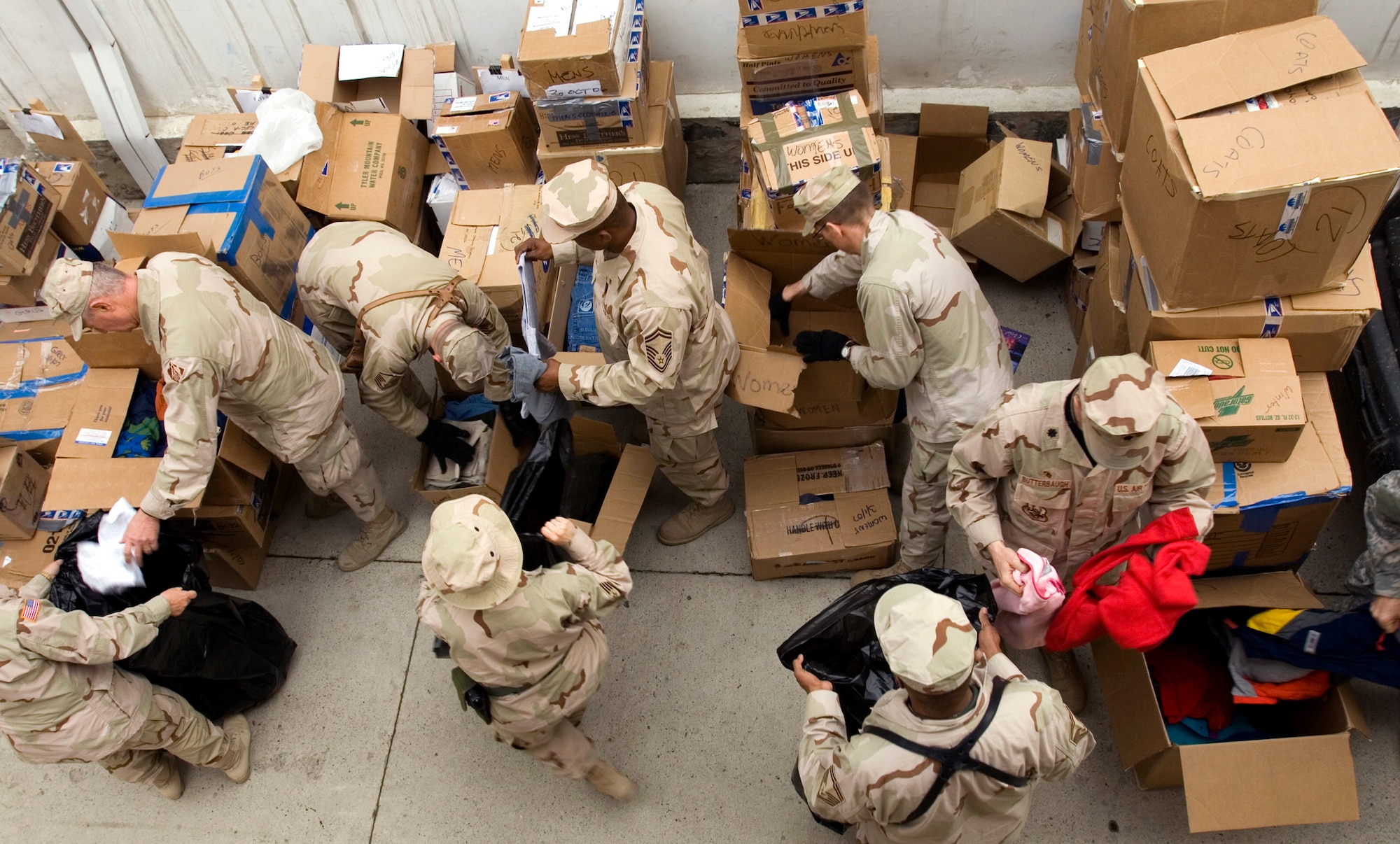 Department of Defense civilians and coalition servicemembers banded together March 16 to sort bags of clothes, toys, and shoes to donate to approximately 1,000 local Afghans at a refugee camp in Dar Ul Aman in support of the volunteer community reach program.  The program volunteers provide this service every month thanks to the donated items received from U.S. citizens.  (U.S. Air Force photo/Tech. Sgt. Cecilio M. Ricardo Jr.) 