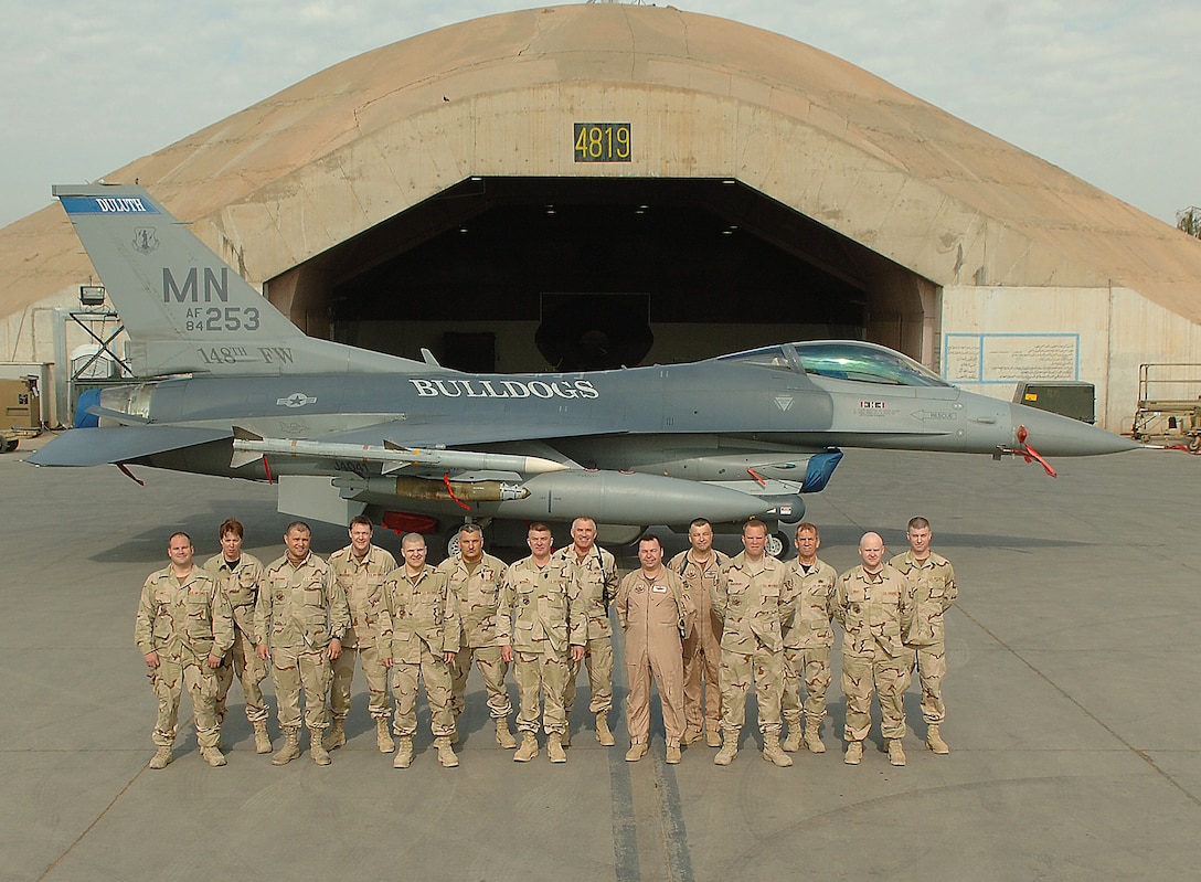 BALAD AIR BASE, Iraq -- Airmen from the 148th Fighter Wing, Duluth Air National Guard Base, Minn., pose for a 'family' photograph. Of the more than 250 Duluth Guardsmen deployed here to the 332nd Expeditionary Fighter Wing's 'Tuskegee Airmen,' 41 are related. Pictured above are (left to right, front to back): spouses SSgts Ethan and Julie Ault; cousins TSgt Wayne and MSgt Darin Gressman; son SrA Matthew and father MSgt Dennis Holland; brothers TSgt David and CMSgt Ken McDonald; brothers LtCol Jim and Col John Spencer; son SSgt Trever and father SMSgt Stephen Vanderburg; and cousins TSgts Todd West and Ryan Niesen. (U.S. Air Force photo/Airman 1st Class Nathan Doza)