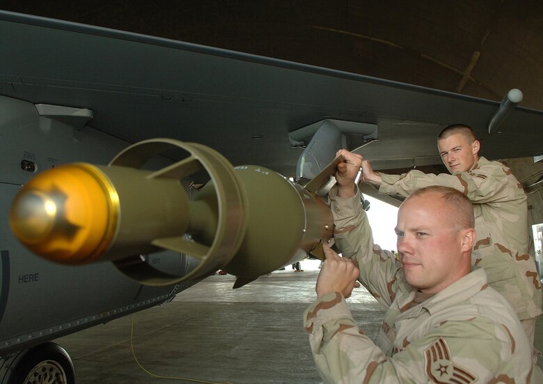 BALAD AIR BASE, Iraq -- Staff Sgt. Zachary Scouton (front) and Airman 1st Class Ben Butcher, 332nd Expeditionary Aircraft Maitenance Squadron inspect a GBU-12 laser-guided bomb on an F-16. Airman Butcher is deployed here with his father, Col. Jay Butcher, 332nd Expeditionary Fighter Squadron. Of the more than 250 Duluth Air National Guard Base Airmen deployed here to the 332nd Expeditionary Fighter Wing's 'Tuskegee Airmen,' 41 are related. (U.S. Air Force photo/Airman 1st Class Nathan Doza)