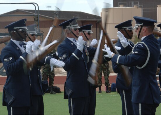 The 16 members of the Air Force Honor Guard Drill Team spin the M-1 rifle with fixed bayonet during a performance at the Holloman Fitness and Sports Center football field. The Drill Team mission is to recruit, retain and inspire for Air Force Recruiting Service. (U.S. Air Force photo by Airman 1st Class John Strong)