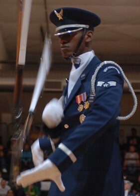 A member of the Air Force Honor Guard Drill Team spins the M-1 rifle with precision and skill during a performance at Alamogordo High School. The Drill Team mission is to recruit, retain and inspire for Air Force Recruiting Service. (U.S. Air Force photo by Airman 1st Class John Strong)