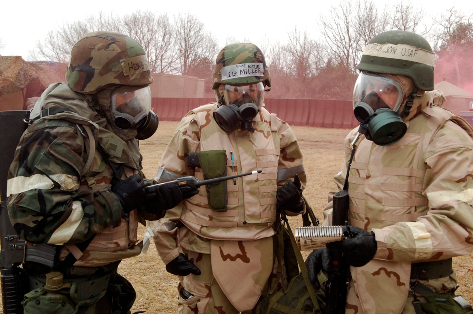 From left, 1st Lt. Thomas Heine, Air Force Research Laboratory, 2nd Lt. Katie Miller, 753rd Intelligence Squadron, and Airman 1st Class Jonathan Blanck, AFRL, consult the Airman's Manual, AFMAN 10-100, while using a radio to communicate with the Air Base Defense Unit Control Center tent at Camp Patriot. Operations at Camp Patriot continued for 24-hours per day with Airman reporting for both day and night shifts. (U.S. Air Force Photo by Mark Wyatt)