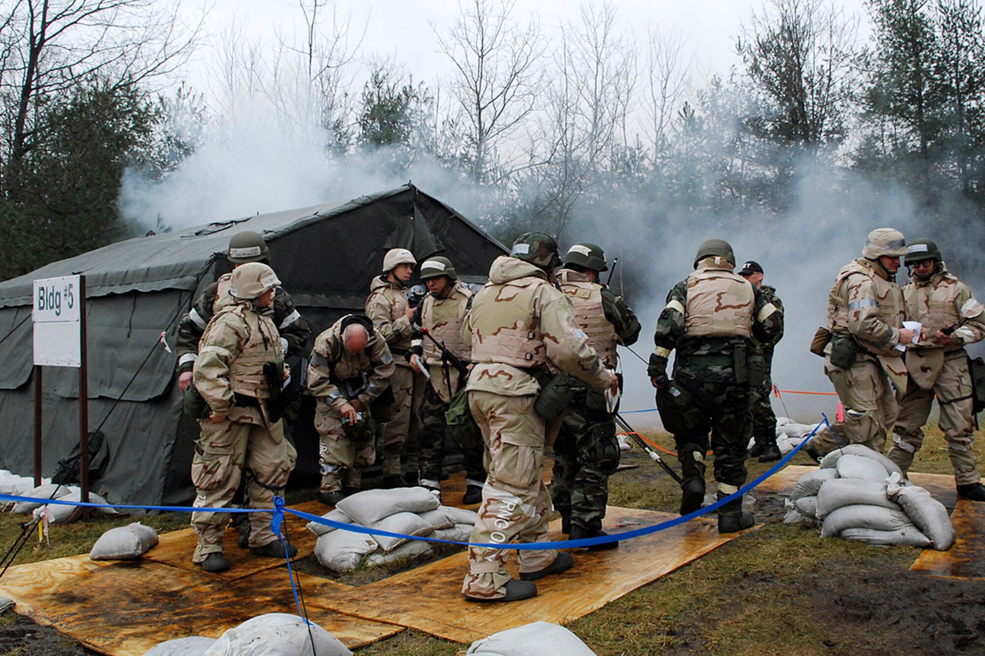 Members of the Air Base Wing Unit Control Center tent at Camp Patriot evacuate following a simulated fire March 15 during the March Base Readiness Exercise. Approximately 140 Airmen "deployed" to Camp Patriot to demonstrate their ability to survive and operate in a field environment. (U.S. Air Force Photo by Walter Santos)