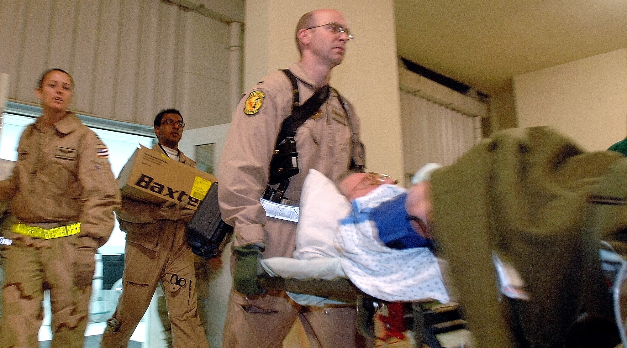 First Lt. Shane House and other medical air crew members load patients onto ambulances before loading them onto an awaiting aircraft for the first non-stop medical evacuation flight from Bagram, Afghanistan, to Landstuhl, Germany, March 21. The normal three- to five-day route through Kuwait to Landstuhl has been reduced to a 10-hour direct flight to provide faster service to wounded servicemembers and Department of Defense civilians. (U.S. Air Force photo/Tech. Sgt. Cecilio M. Ricardo Jr.)