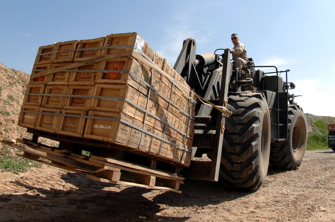 Senior Airman David Hallmon loads a pallet of ammunition March 21 at Kirkuk Air Base, Iraq, onto a truck for delivery to expeditionary security forces Airmen who provide security to the base.  Senior Airman Hallmon is a munitions specialist with the 506th Air Expeditionary Group.  (U.S. Air Force photo/Senior Airman Bradley A. Lail)
