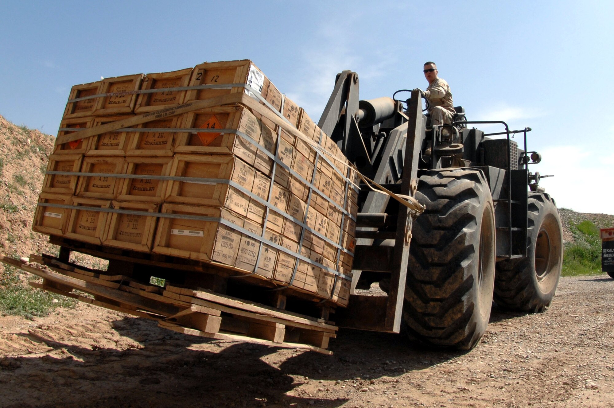 Senior Airman David Hallmon loads a pallet of ammunition March 21 at Kirkuk Air Base, Iraq, onto a truck for delivery to expeditionary security forces Airmen who provide security to the base.  Senior Airman Hallmon is a munitions specialist with the 506th Air Expeditionary Group.  (U.S. Air Force photo/Senior Airman Bradley A. Lail)