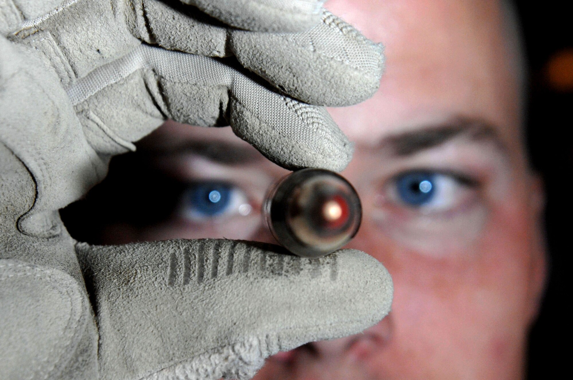 Senior Airman David Hallmon inspects an unfired 50 caliber round March 21 at Kirkuk Air Base, Iraq.  All unserviceable ammo is sent to the explosive ordnance disposal team for detonation. Airman Hallmon is a munitions specialist with the 506th Air Expeditionary Group.  (U.S. Air Force photo/Senior Airman Bradley A. Lail)
