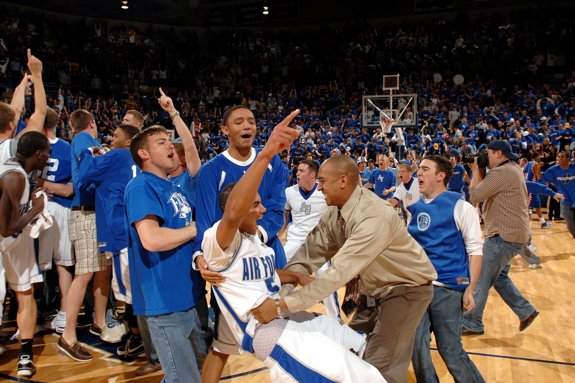 Falcon guard Matt McCraw, 5, fans and teammates celebrate Air Force's 52-51 win over DePaul March 21 at Clune Arena. The victory earned the bluesuiters a berth in the NIT semifinals in New York City's Madison Square Garden March 27 against Clemson. (U.S. Air Force photo/Danny Meyer) 