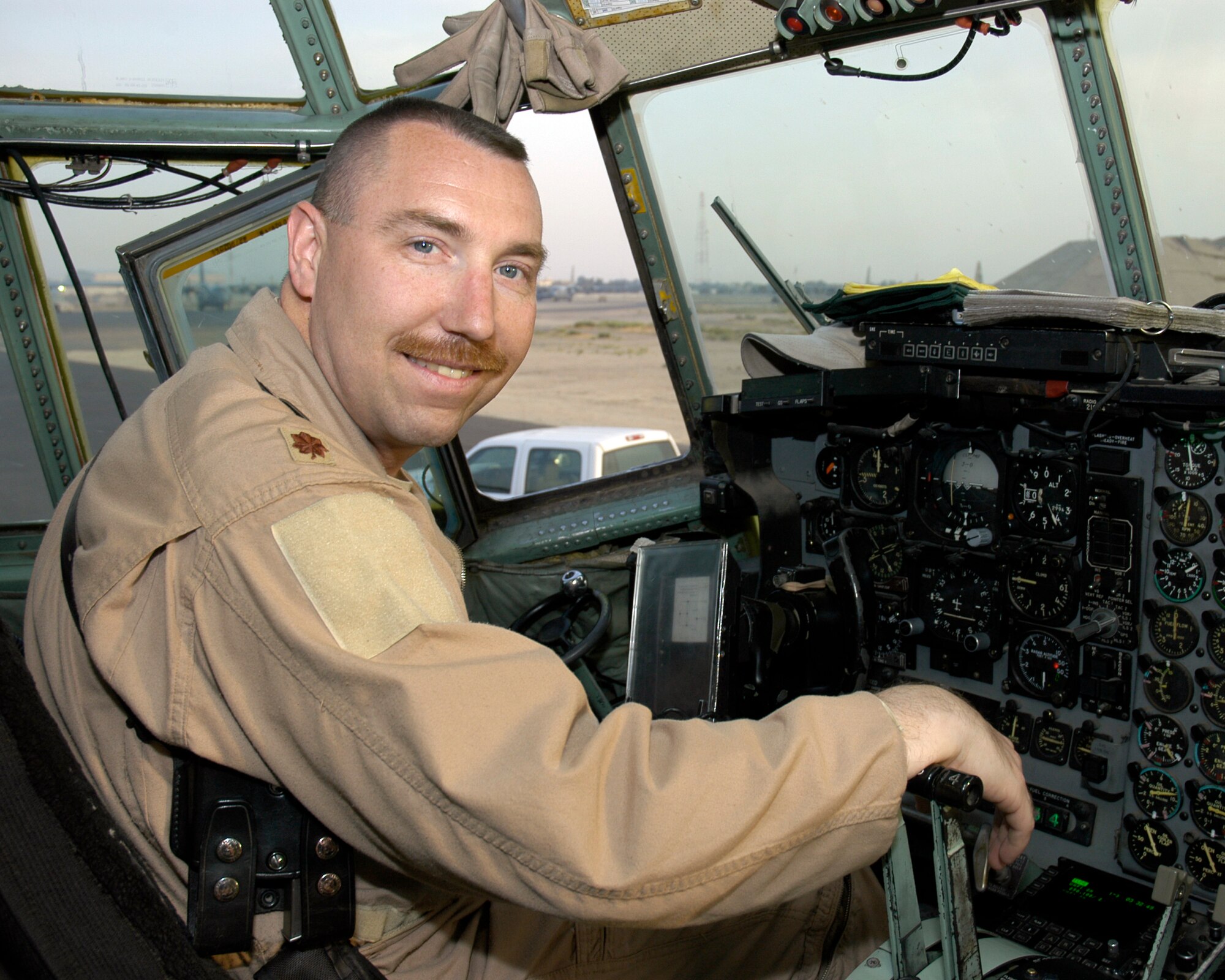 SOUTHWEST ASIA --   Maj. Jon Watson, 737th Expeditionary Airlift Squadron Pilot, in the cockpit of a C-130E Hercules prior to departing for the mission that would take him over 1,000 combat hours on March 22, 2007. The 16-year Air Force veteran has flown missions all over the CENTAF Area of Responsibility. (AF photo/ Staff Sgt. Ian Carrier)                            
