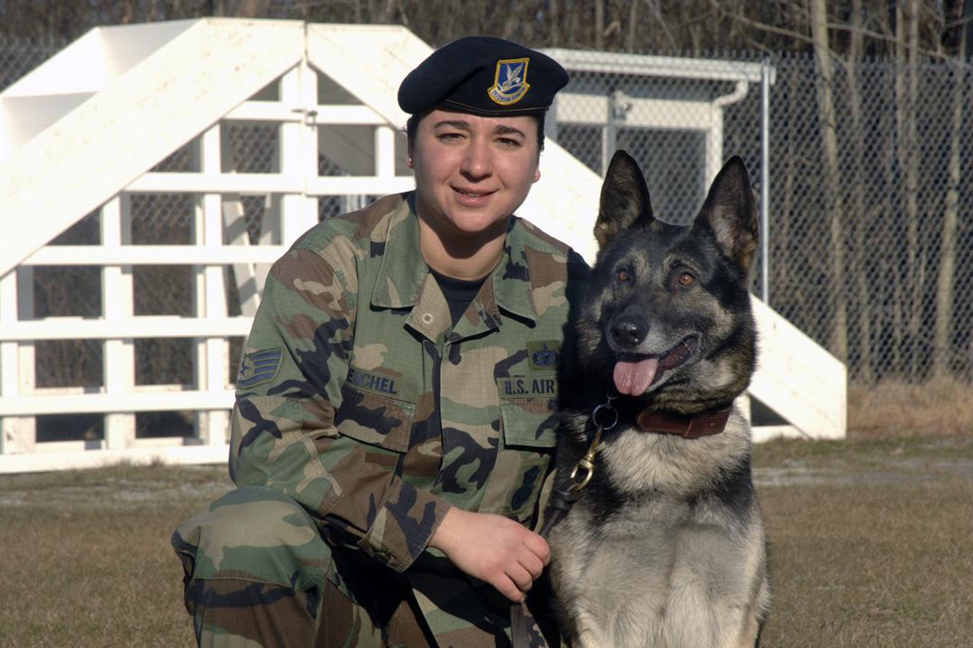 Staff Sergeant Jeanette Reichel, 66th Security Forces Squadron, poses with her Military Working Dog, Petya, a 6-year old German Sheppard, tattoo F-028. Sergeant Reichel entered the Hanscom history books on March 21 as the first female dog handler here in the past two decades after successfully completing her handler certification. (U.S. Air Force Photo by Linda LaBonte Britt)