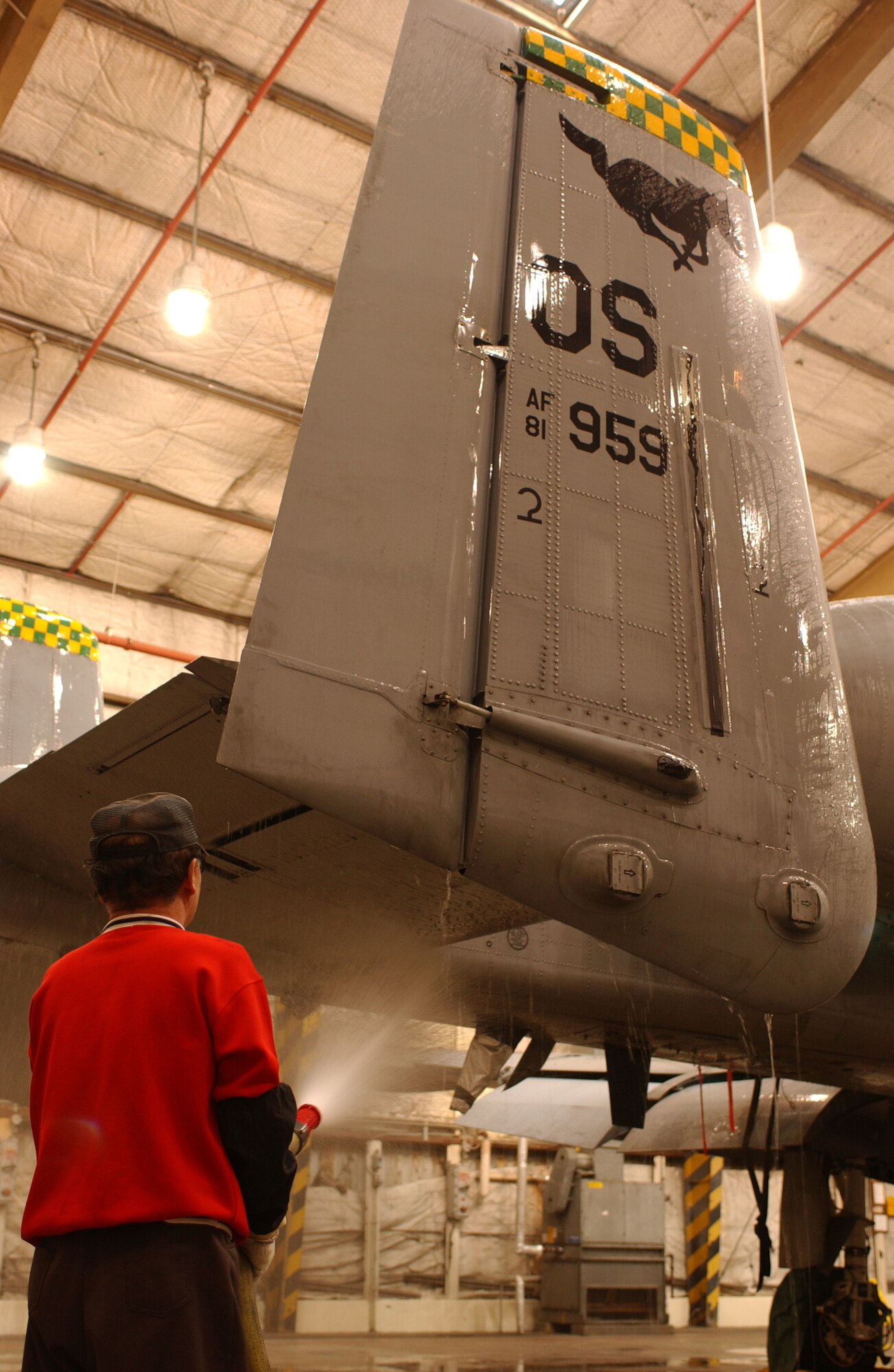 An A-10 Thunderbolt gets hosed down during a routine wash here March 16. Jets are washed every 90 days here to keep them from deteriorating. The amount of time that passes between washes is based on the environment where jets are stationed. For example, a jet that is stationed near sea water is washed more often than one that is in a dry climate. (U.S. Air Force photo by Airman Jason Epley)