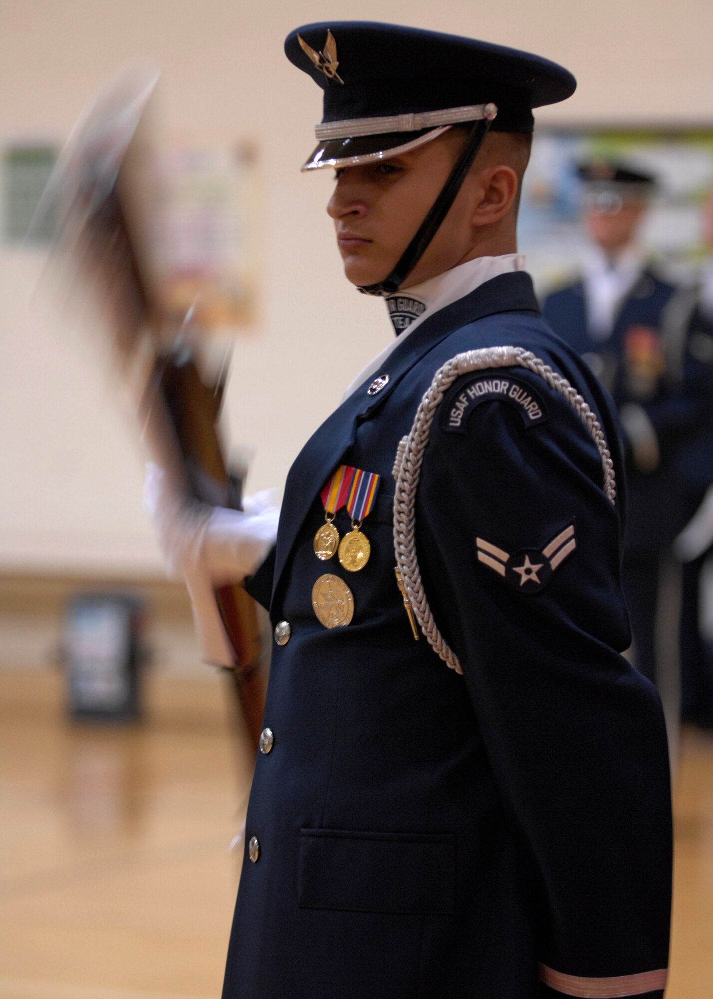 Airman 1st Class Adrian Santiago and the other United States Air Force Honor Guard Drill Team members perform at the West Fitness Center on Kirtland Air Force Base, N.M., March 15, 2007. The Drill Team is the traveling component of the Air Force Honor Guard and tours Air Force bases world wide showcasing the precision of today's Air Force to recruit, retain, and inspire Airmen for the Air Force mission. (U.S. Air Force photo by Airman 1st Class Rusti Caraker)(Released)