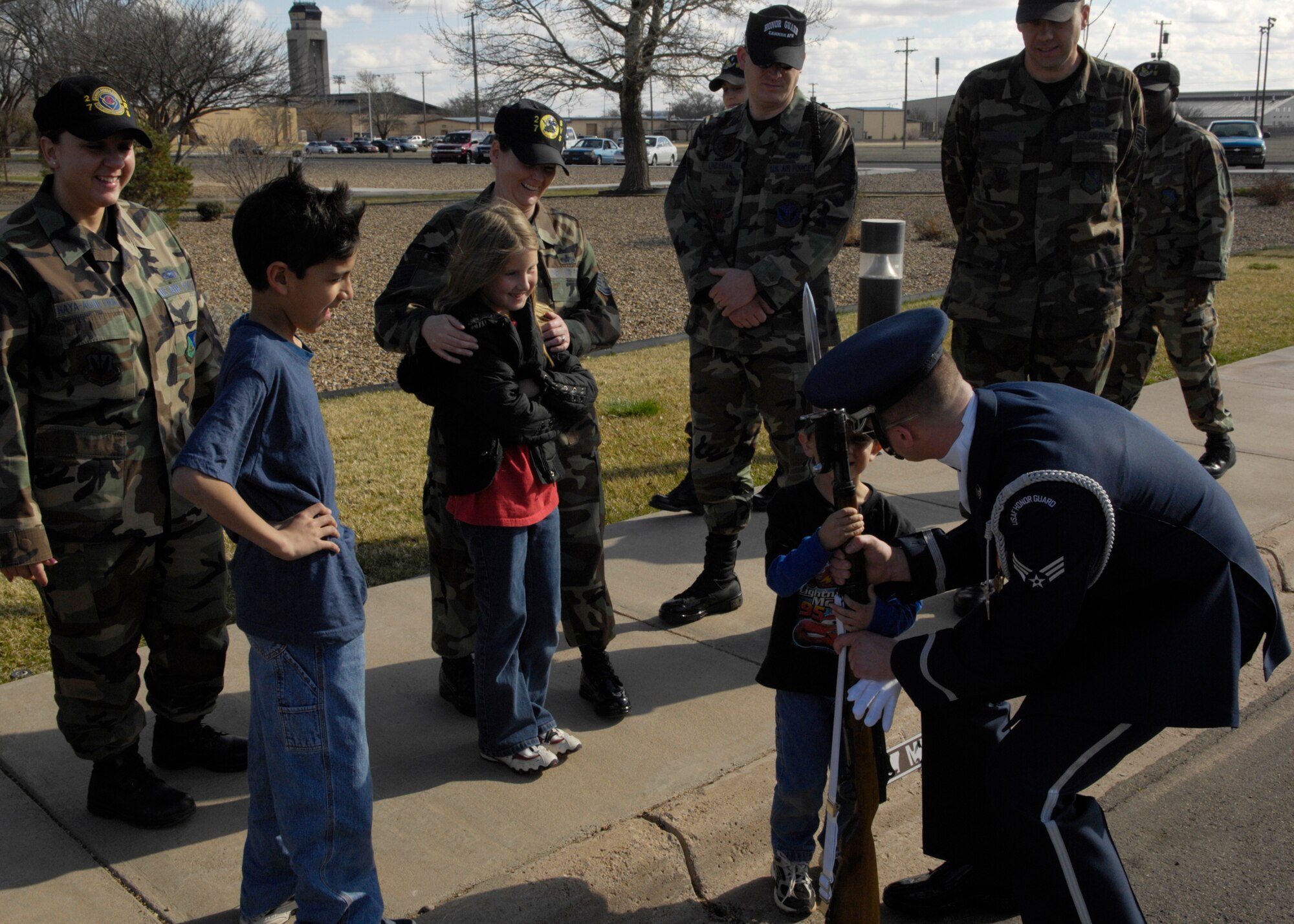 Senior Airman Timothy Treadway of the United States Air Force Honor Guard Drill Team talks to Neki Raya, son of Tech. Sgt. Donna Raya, 27th Logistics Readiness Squadron, at Cannon Air Force Base, N.M., March 13, 2007. The Drill Team is the traveling component of the Air Force Honor Guard and tours Air Force bases world wide showcasing the precision of today's Air Force to recruit, retain, and inspire Airmen for the Air Force mission. (U.S. Air Force photo by Airman 1st Class Rusti Caraker)(Released)