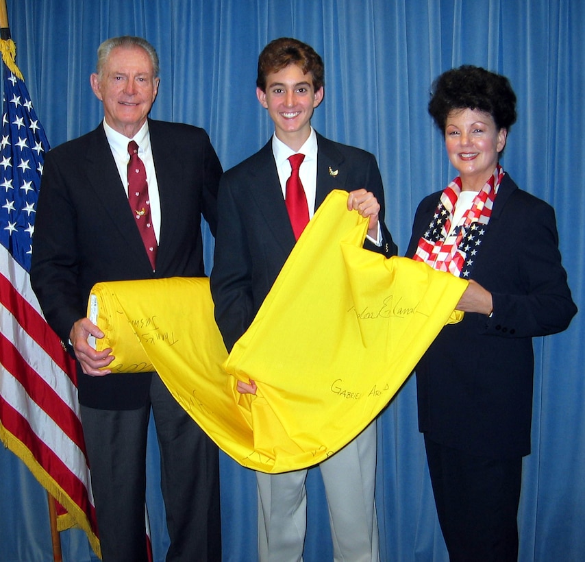Seventeen-year-old Matthew Cook (center) stopped at the Pentagon with his parents, David and Sharon Cook, while visiting Washington to collect signatures on a section of yellow ribbon. Cook has arranged to ship the ribbon -- which now stretches a mile long -- to Iraq this fall as a show of young people’s support for deployed troops. Photo by Donna Miles