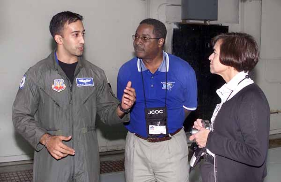Air Force Capt. Murali Krishnan discusses an earlier  F-15 fighter jet demonstration at Langley Air Force Base, Va., with  Sidney McPhee (center), president of Middle Tennessee State University,  Murfreesboro, Tenn., and Rosemary DePaolo, president of Georgia College  and State University at Milledgeville, Ga. Photo by Spc. Tyler  Davidson, USA.