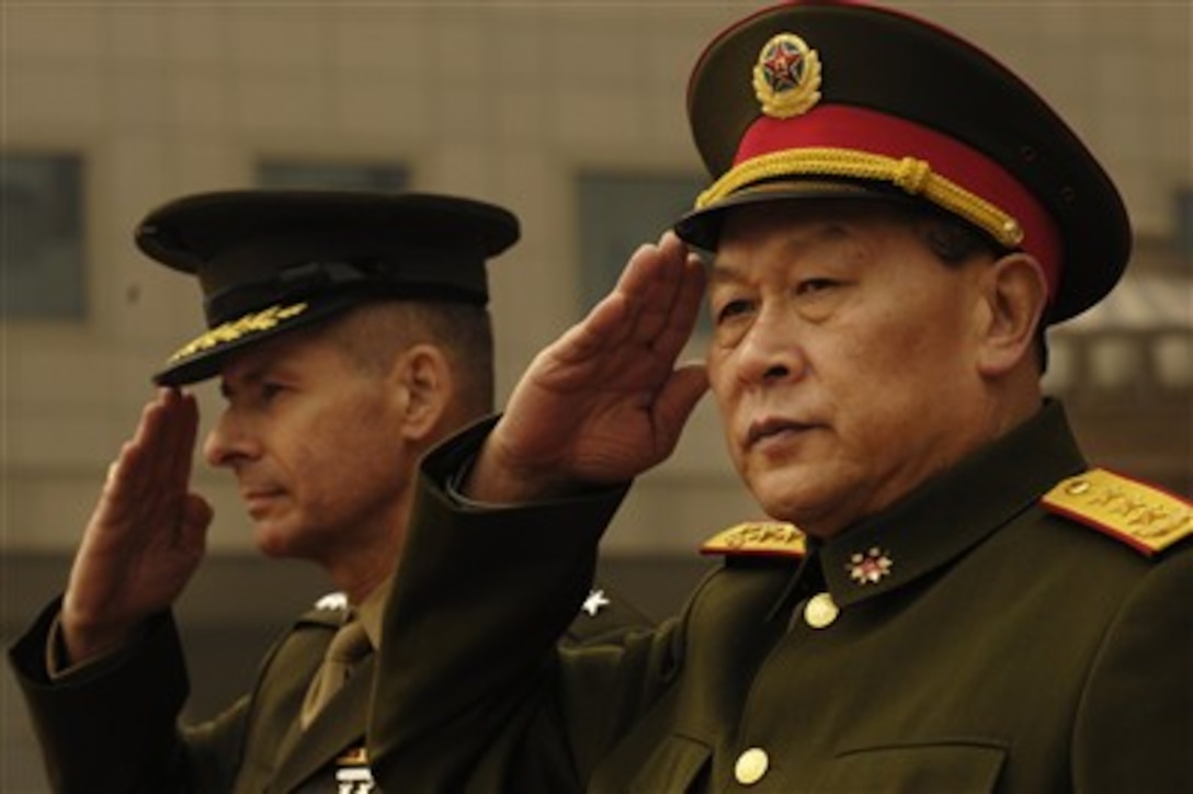 Chairman of the Joint Chiefs of Staff Gen. Peter Pace (left), U.S. Marine Corps, and his Chinese counterpart, Chinese People's Liberation Army Gen. Liang Guanglie salute during an honor guard ceremony during Pace's visit to the Ministry of Defense in Beijing, China, on March 22, 2007.  