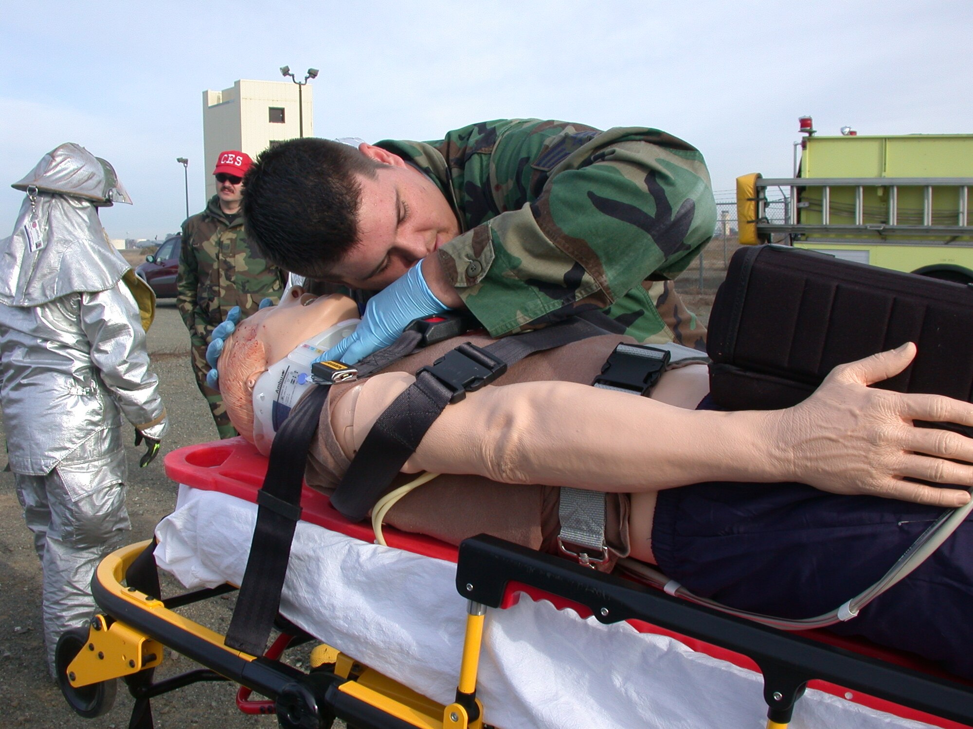 Senior Airman Nick Eischen, 60th Medical Operations Squadron emergency medical technician, checks for breathing on the victim, an interactive remotely controlled mannequin, during a recent Joint Emergency-Fire Department Trauma Response Exercise at Travis. The exercise tested the Emergency and Fire department’s trauma inter-agency team performance in responding to a life-threatening emergency. (U.S. Air Force photo by Tech. Sgt. Austin Delacruz, 60th Medical Operations Squadron)