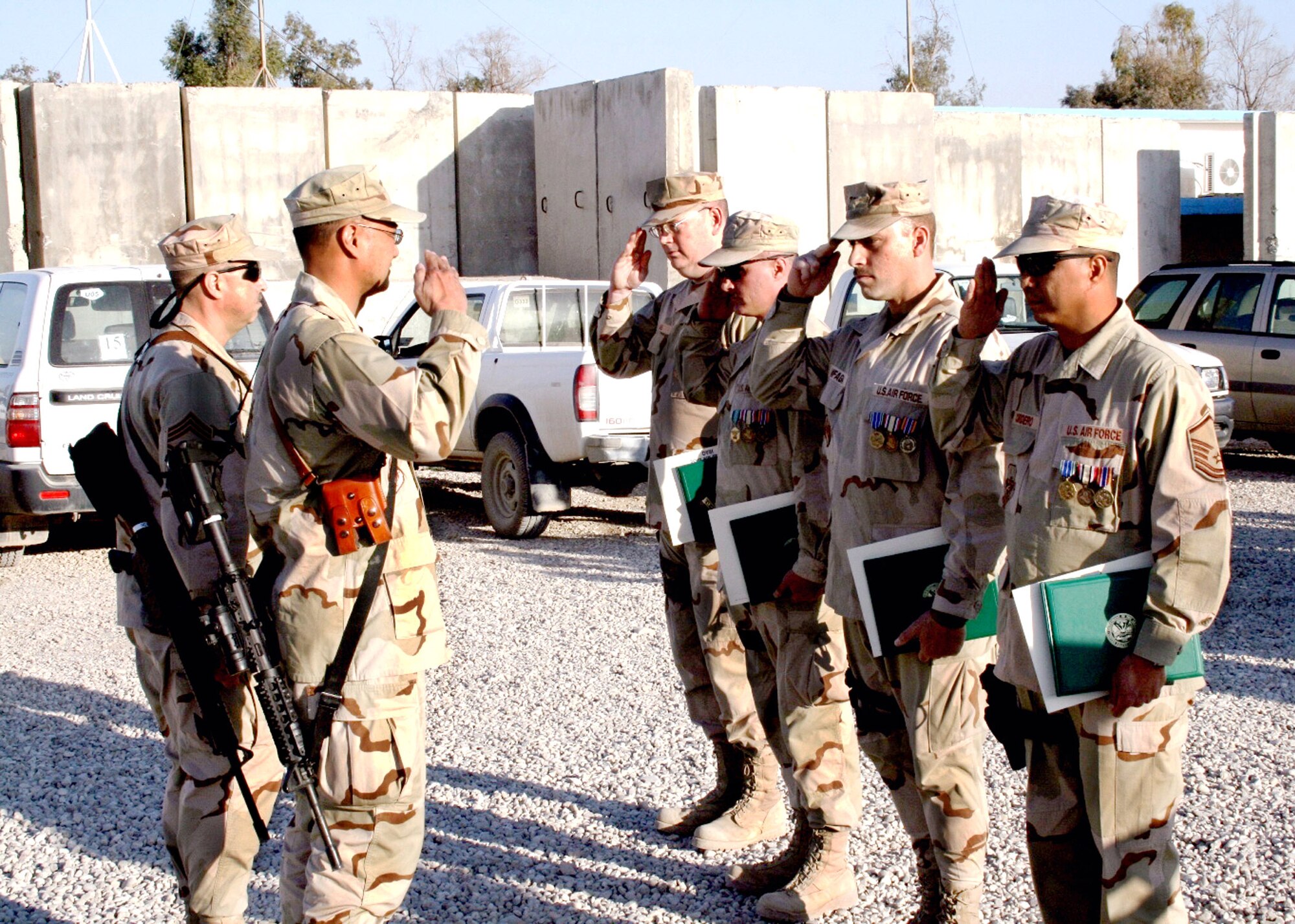 (From left) Master Sgts. Kenneth Hans, John Murrell, Ralph Zanfagna and Jaime Cordero, Jr., salute Lt. Col. Geoffrey Ellazar, 732nd Expeditionary Support Squadron commander, after receiving Iraqi Campaign and Air Force Expeditionary medals. The sergeants were administratively assigned to the 732nd EMSG and operationally attached to the Army's 403rd Civil Affairs Battalion. (U.S. Air Force photo/Capt. Ken Hall)