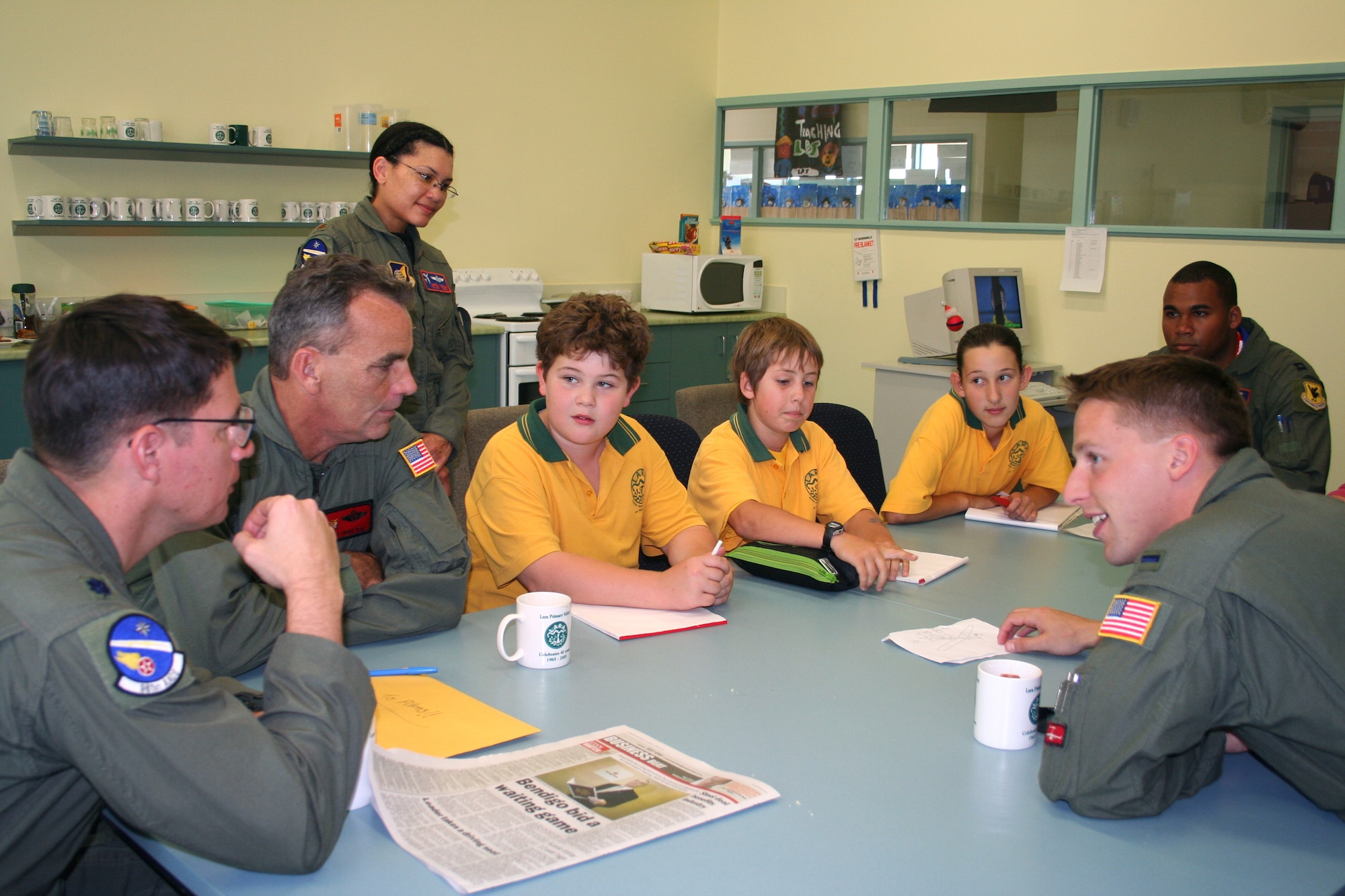 Lt. Col. Pete Bastien from Kadena Air Base, Japan; Master Sgt. Chuck Fish of Hickam Air Force Base, Hawaii; Maj. Janel Egana and Capt. C. D. Henderson from Kadena AB; and 1st Lt. Ryan Freeman of Hickam AFB talk to Lara Primary School sixth-graders Liam Carter, Brandon Steele and Andrea Lackovic on how to build a model airplane for their school project. The Airmen visited the school in Victoria, Australia, March 22 to speak to students about being in the Air Force. They are in Australia supporting Australian International Airshow 2007. (U.S. Air Force photo/Capt. Yvonne Levardi) 