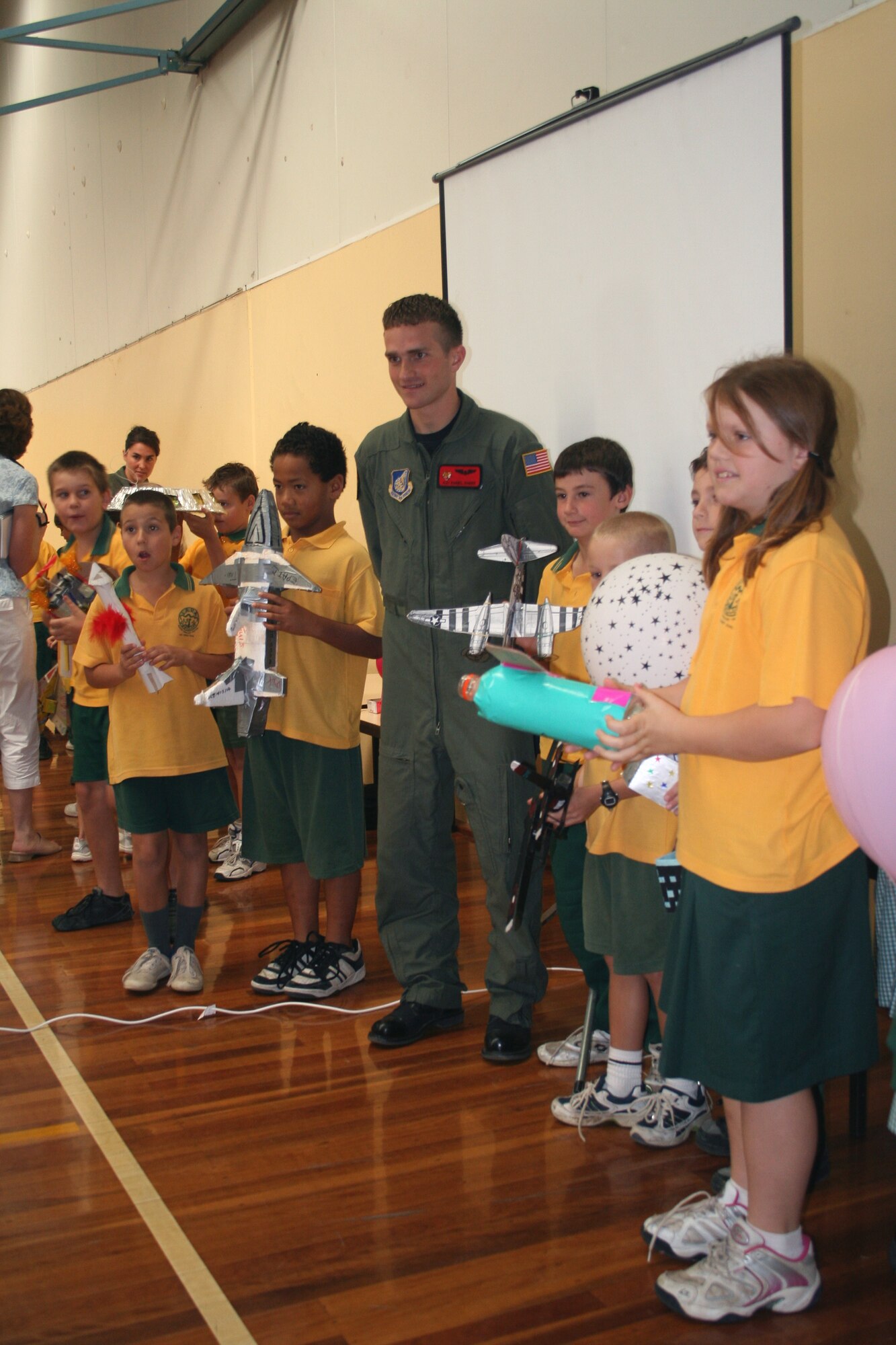 Airman 1st Class Daniel Baker poses with students from the Lara Primary School in Victoria, Australia.  Airman Baker and other Pacific Air Forces Airmen visited the school March 22 to speak to students about being in the Air Force. The Airmen are in Australia supporting Australian International Airshow 2007. Airman Baker is a loadmaster with the 535th Airlift Squadron at Hickam Air Force Base, Hawaii. (U.S. Air Force photo/Capt. Yvonne Levardi) 