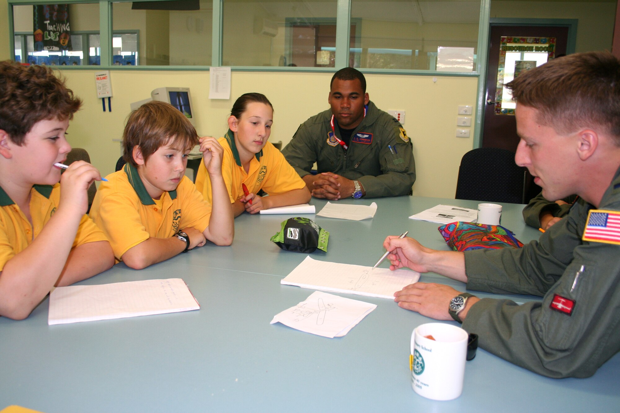 First Lt. Ryan Freeman gives advice to Lara Primary School sixth-graders Liam Carter, Brandon Steele and Andrea Lackovic on how to build a model airplane for their school project as Capt. C.D. Henderson observes. The Airmen visited the school in Victoria, Australia, March 22 to speak to students about being in the Air Force. They are in Australia supporting Australian International Airshow 2007. Lieutenant Freeman a pilot with the 535th Airlift Squadron at Hickam Air Force Base, Hawaii, and Captain Henderson is an electronic warfare officer with the 961st Airborne Air Control Squadron at Kadena Air Base, Japan. (U.S. Air Force photo/Capt. Yvonne Levardi) 