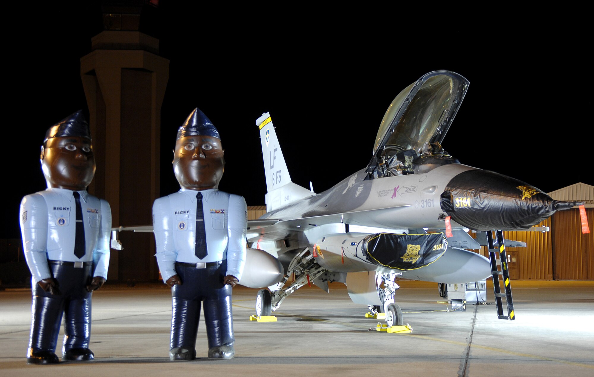 Two larger than life Airmen stand beside an F-16C Fighting Falcon as one of the backdrops to Good Morning Arizona, a morning show remotely filmed at Luke Air Force Base March 22. The show featured demonstrations from different careers throughout the Air Force and helped promote Air Force Week. (U.S. Air Force photo/Staff Sgt. Brian Ferguson)
