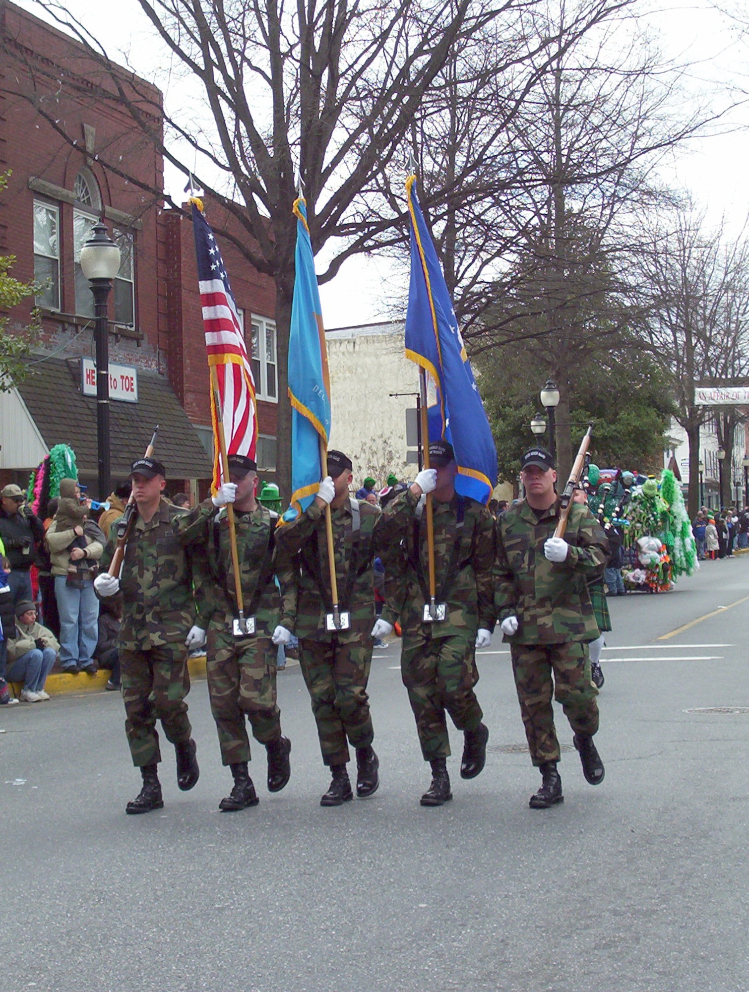 DOVER AIR FORCE BASE, Del. -- The Dover Air Force Base Honor Guard carries Old Glory, the Delaware State Flag and the Air Force Flag while leading Dover's 14th Annual St. Patricks Day Parade. More than 50 Dover AFB members participated in the parade. (U.S. Air Force photo/Susan Walls)