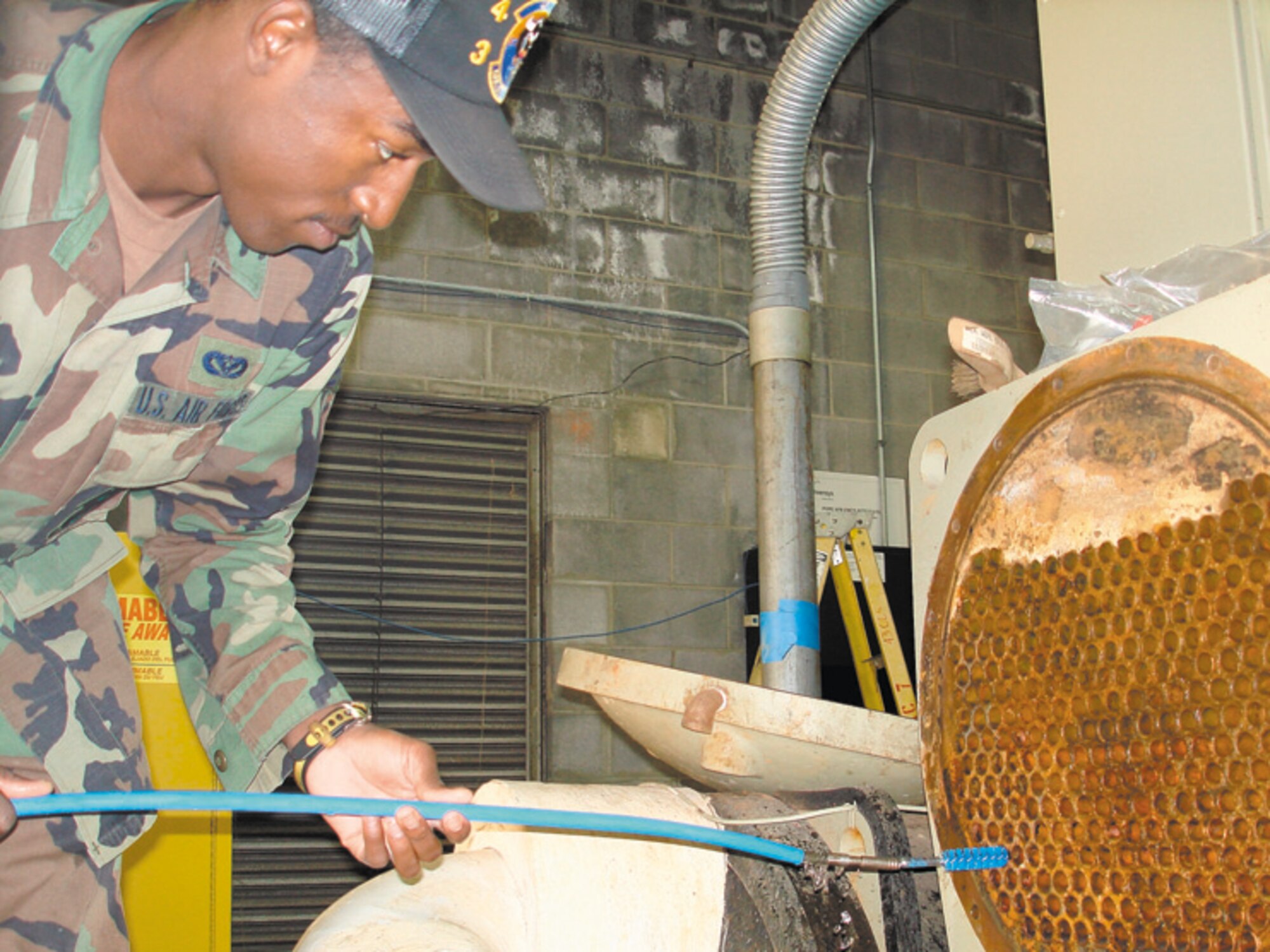 Senior Airman Lamar Reece, 43rd Civil Engineer Squadron, cleans the centrifugal chiller at building 395 as part of preventive maintenance in preparation for the upcoming cooling season. The 43rd CES heating, ventilation and air conditioning section prepares base cooling systems so they'll be ready to beat the summer heat.