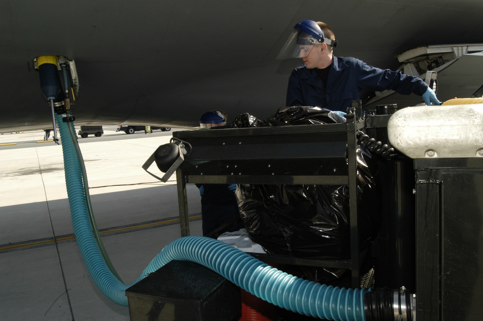 DOVER AIR FORCE BASE, Del. -- Christopher Wilson, 436th Aerial Port Squadron Fleet Services Flight, pumps clean ‘blue juice’ into an aircraft after draining the waste from the lavatories on board.  Fleet Services ensures all aircraft at Dover, regardless of origin, are clean and serviceable for aircrews and passengers 24 hours a day, 365 days a year. (U.S. Air Force photo/Senior Airman James Bolinger)                               