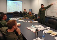 MINOT AIR FORCE BASE, N.D. -- Capt. Matthew Lewis, a B-52H Stratofortress pilot in the 23rd Bomb Squadron, discusses a mission plan for a flyover at Arlington National Cemetery, Va. A B-52 assigned here performed a flyover March 21 to support the military funeral of retired Gen. Louis Seith, former chief of staff for Supreme Headquarters Allied Powers Europe and World War II pilot. (U.S. Air Force photo by Airman 1st Class Wesley Wright)