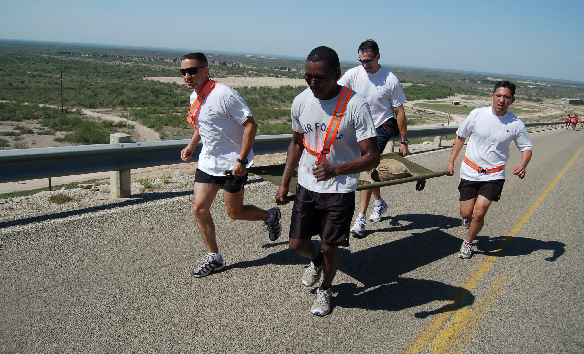 LAUGHLIN AIR FORCE BASE, Texas -- The 47th Flying Training Wing's team reaches the top of a hill during the litter-carry portion of the 2006 Laughlin Adventure Race.  (U.S. Air Force photo by Staff Sgt. Austin M. May)