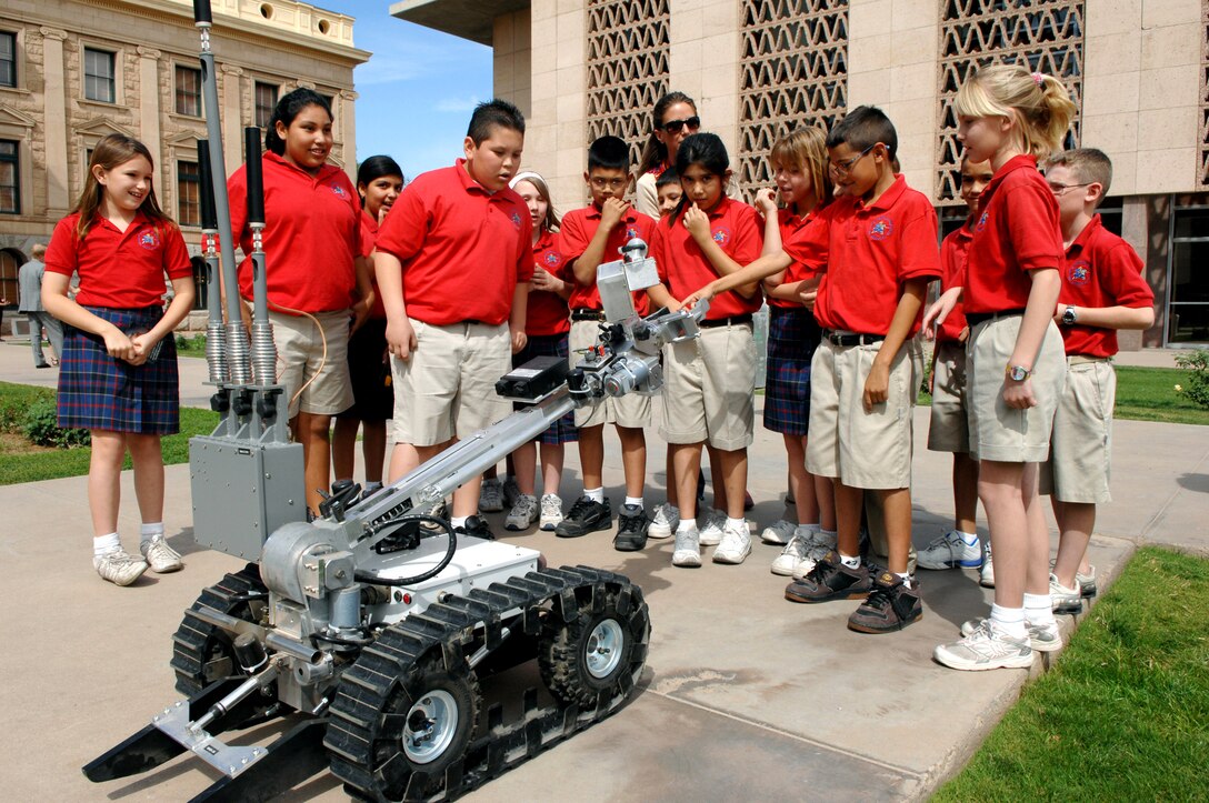 Students from a local school check out one of the Air Force explosive ordnance disposal robots during a field trip to the Arizona Science Center in downtown Phoenix.  EOD specialists from nearby Luke Air Force Base brought the robot to help kick off Air Force Week in Phoenix. (U.S. Air Force photo/Staff Sgt. Brian Ferguson)