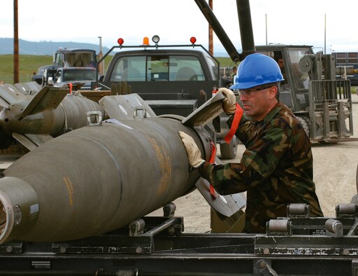 Col. Valentino Bagnani III, 27th Fighter Wing vice commander, pushes a Guided Bomb Unit - 24 down the Munitions Assembly Conveyor at Beal Air Force Base, Calif., March 20. Col. Bagnani was participating in the Air Force Combat Ammunition Center Senior Officer Orientation course. The two-day course provides senior officers an orientation on the concepts and techniques involved in combat munitions planning and production. (U.S. Air Force photo by Capt. Scott Haack)