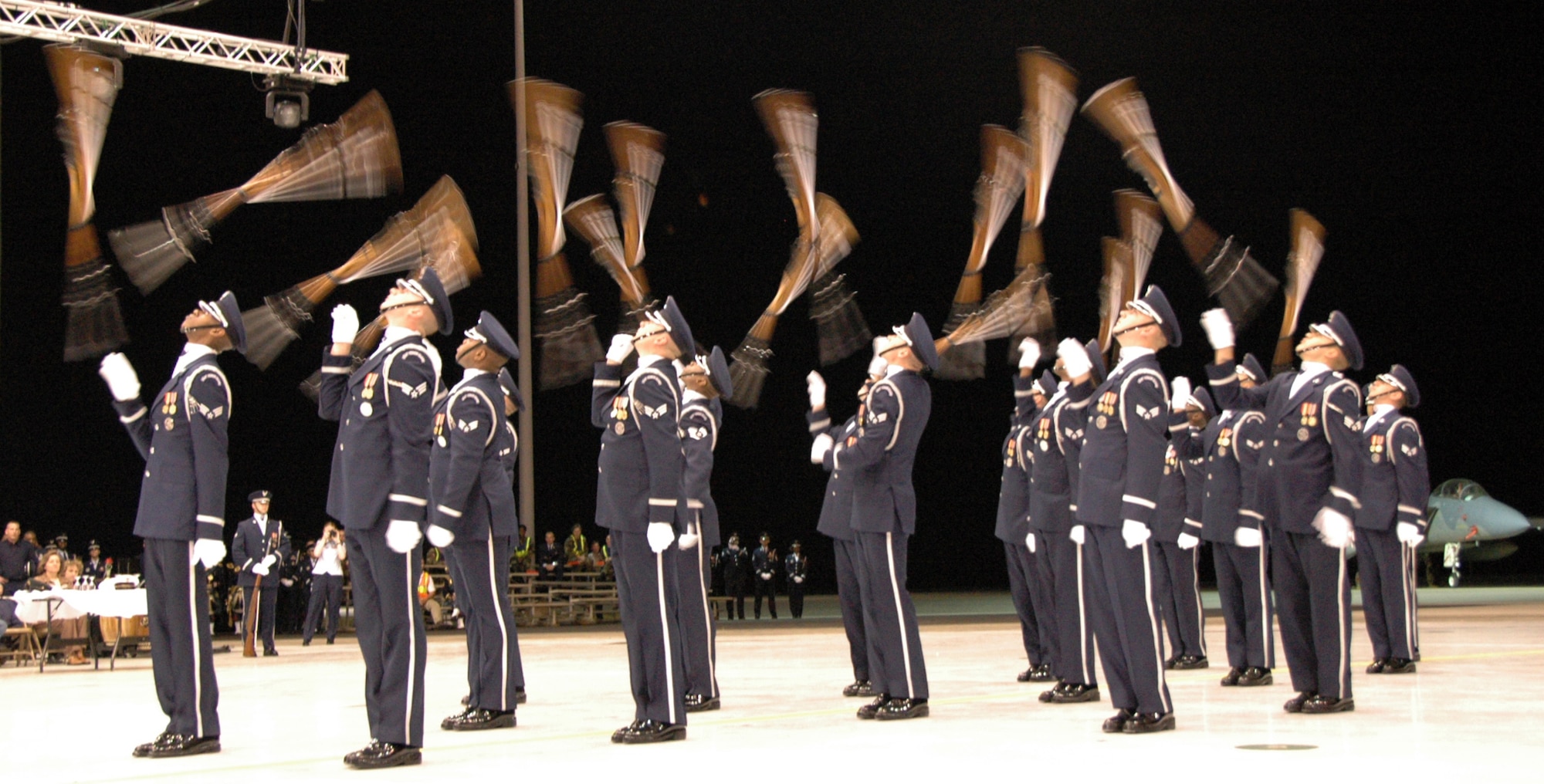 Members of the U.S. Air Force Honor Guard drill team show off their skill with behind the back tosses. U.S. Air Force photo by Sue Sapp 
