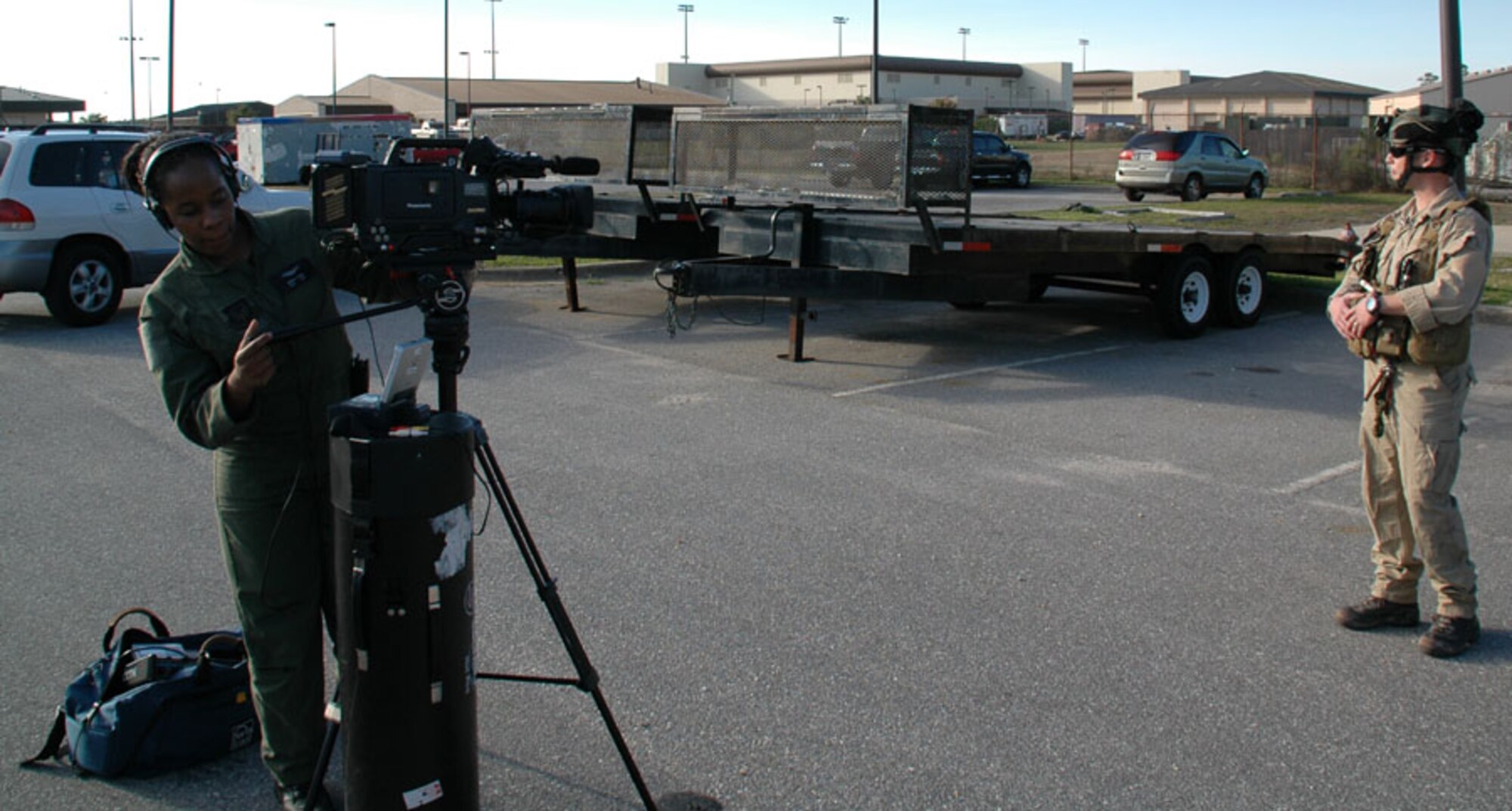 Staff Sgt. Brandy Turner (left), 1st Special Operations Wing Public Affairs Action Team, readies her camera before filming an interview with an Airman March 16. The public affairs office and visual information office are merging to create one team, one fight, one message for Team Hurlburt. (U.S. Air Force photo by Capt. Joseph Coslett)