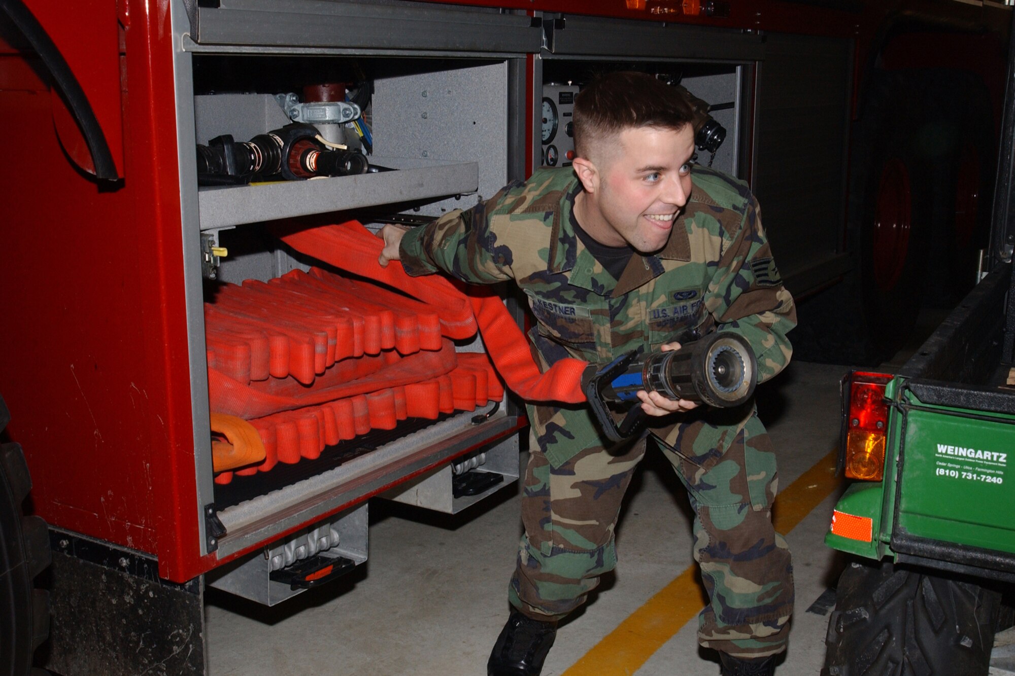 Staff Sgt. Mark Kestner, 927th Civil Engineer Squadron, deploys a hand line from the hand line cabinet of the fire department's newest crash vehicle, the "Stryker", during a training exercise.  Severe winter weather dictated training be conducted in the base fire department.  The 927th CES is a subordinate unit of 927th Air Refueling Wing, an Air Force Reserve Command unit, located at Selfridge Air National Guard Base, Mich.                          