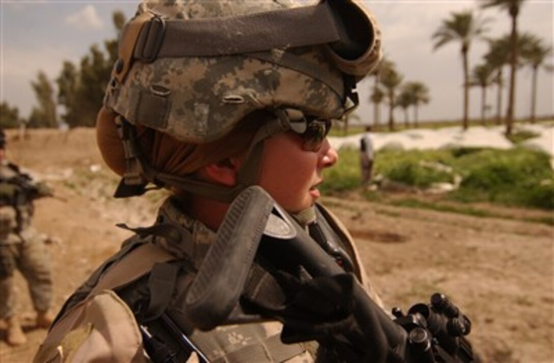 U.S. Army Sgt. Ashley Hort keeps her weapon at the ready as she provides security for her fellow soldiers during a raid in Al Haswah, Iraq, on March 21, 2007.  Hort is a team sergeant with the 127th Military Police Company deployed from Hanau, Germany.  