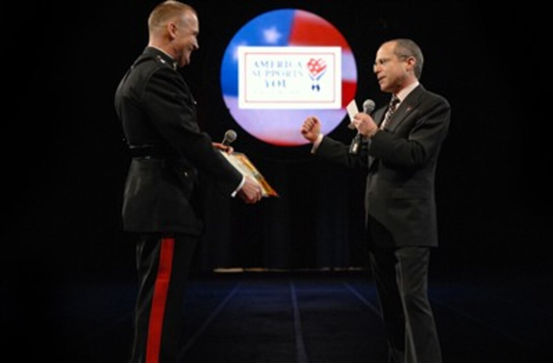 Chief Executive Officer of Feld Entertainment presents U.S. Marine Corps Lt. Gen. John F. Sattler with the ‘Guest Ringmaster’ certificate during the Ringling Brothers and Barnum and Bailey Circus show  in Washington, D.C., March 22, 2007. 
